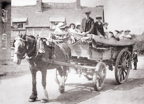 hensons waggon in front of the church of england school in burbage