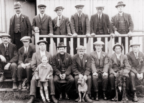 In front of the wooden pavilion just before the First World War. George 'Big Spoff' Charlton is seated at the far left and Wilfrid Hall is seated second from right.