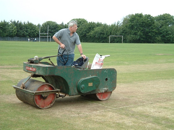 Ian Crisp at work with the 'iron horse' rolling the wicket