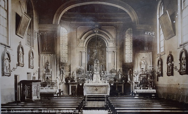 church interior, about 1905, showing the shallow apsidal Renaissance-style sanctuary traditionally dressed and flanked by shrines of Our Lady and St. Peter, with Stations of the Cross and oil paintings adorning the nave walls