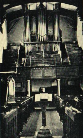 Interior looking west before the restoration, showing the west gallery and organ
